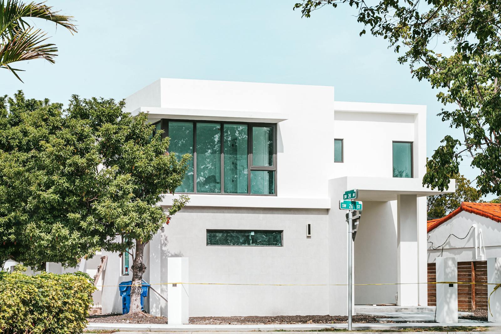 Modern home with large impact-resistant laminated glass windows in a Sierra foothills setting — illustrating hurricane window concepts adapted to California wildfire and wind zones